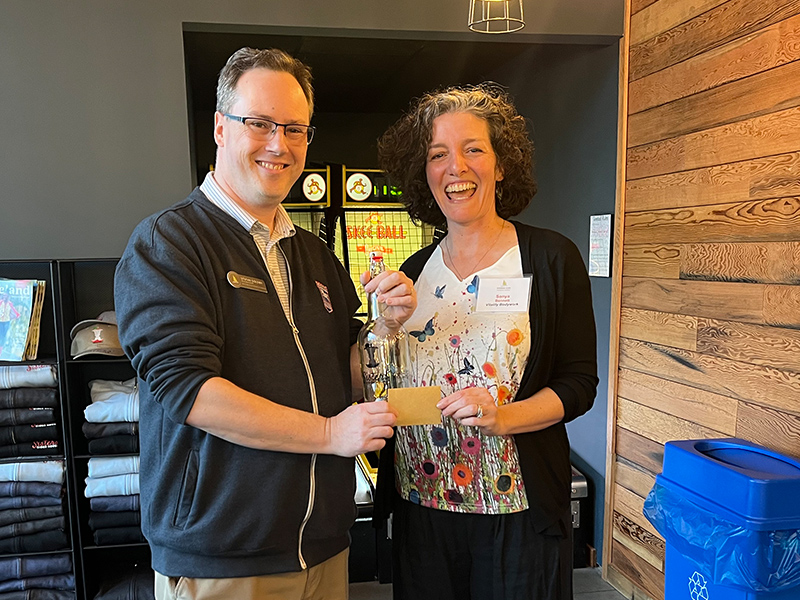 Raffle Winner Sonya Bennett of Vitality Bodywork collects her delicious prize from Chamber President/CEO Stefan Goldby