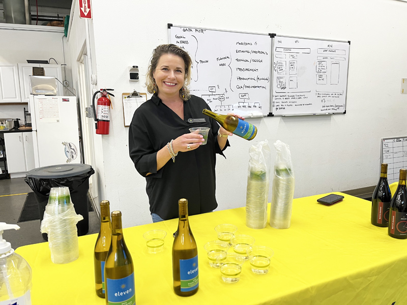 Jessica Perkins from the Chamber pouring Eleven Wine...red or white, which do you prefer?